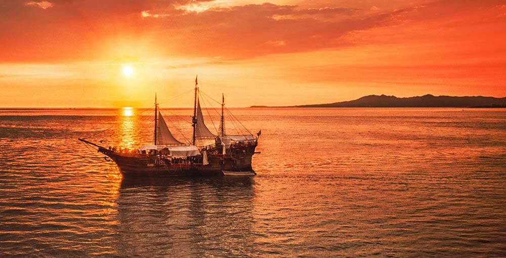 A pirate ship at sunset at a Caribbean Pirate Cruise