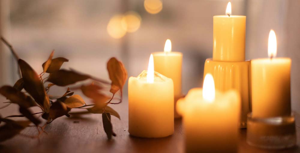 A close-up view of flickering candles casting a warm, intimate glow.