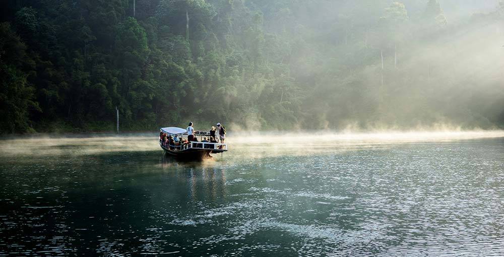 Tourist taking a boat tour at the Black River Safari