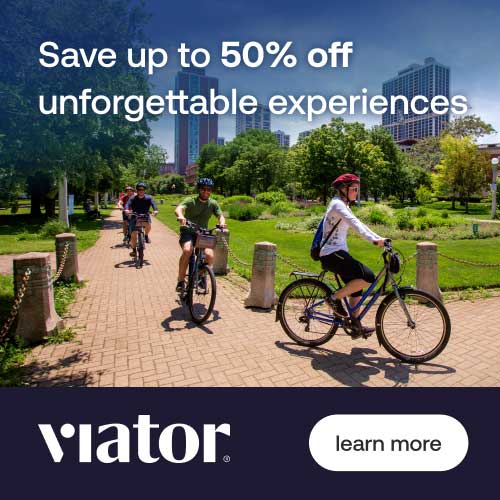 A group of people happily bicycling together at the park, enjoying a sunny day outdoors.