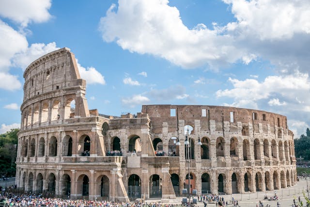 Tourists visiting the Colosseum with a clear view of the ancient monument