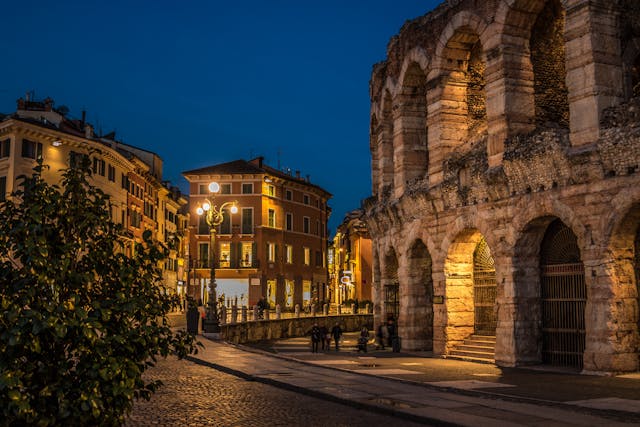 Panoramic view of the Colosseum exterior under blue skies