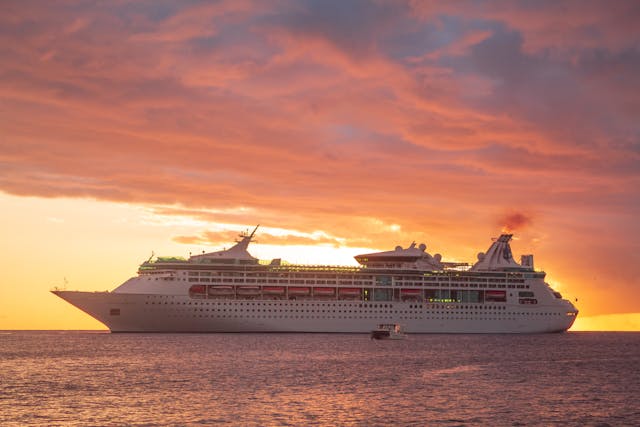 Sunset view of a cruise ship sailing past Grenada in the Caribbean.